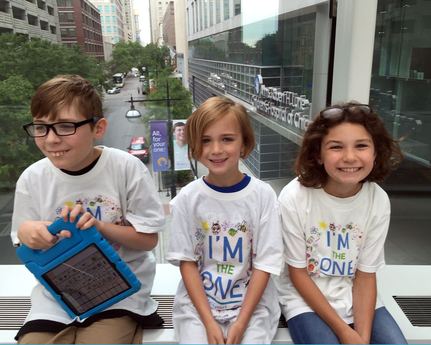 Three kids in matching shirts.