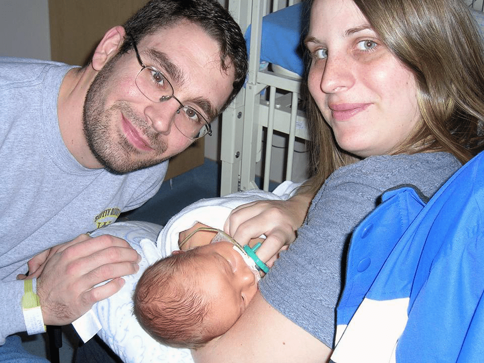 Nathan and wife holding baby in hospital