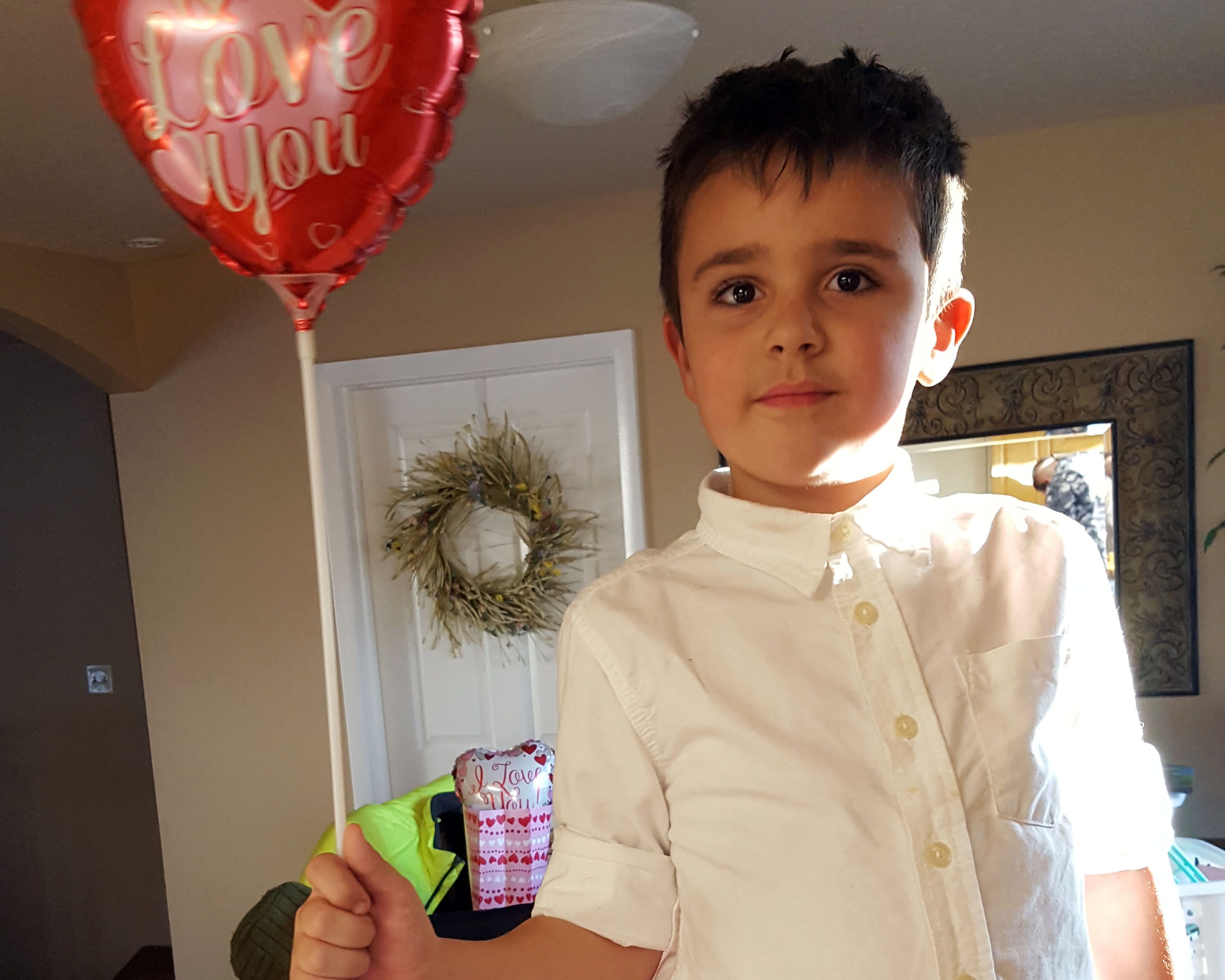 Levi holding a Valentines balloon