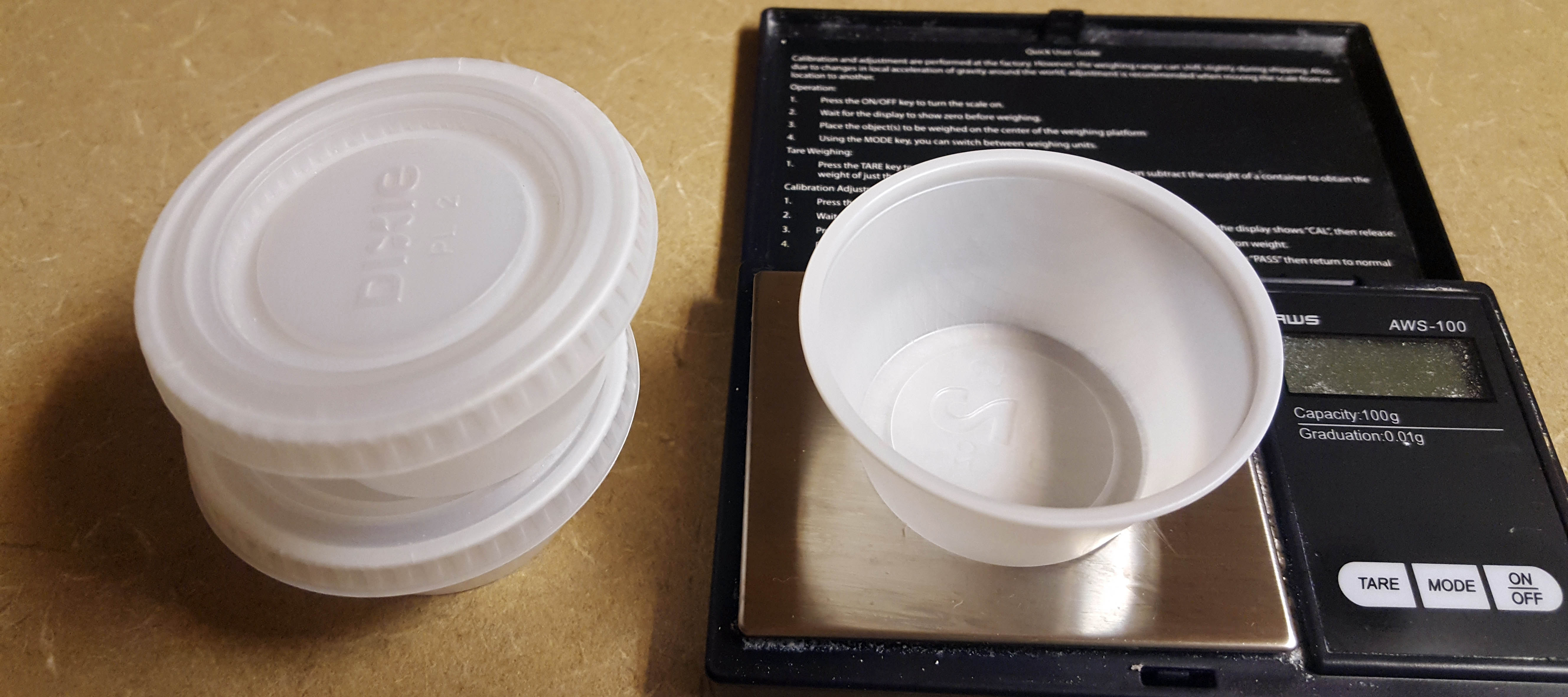 scale and plastic cups with lids