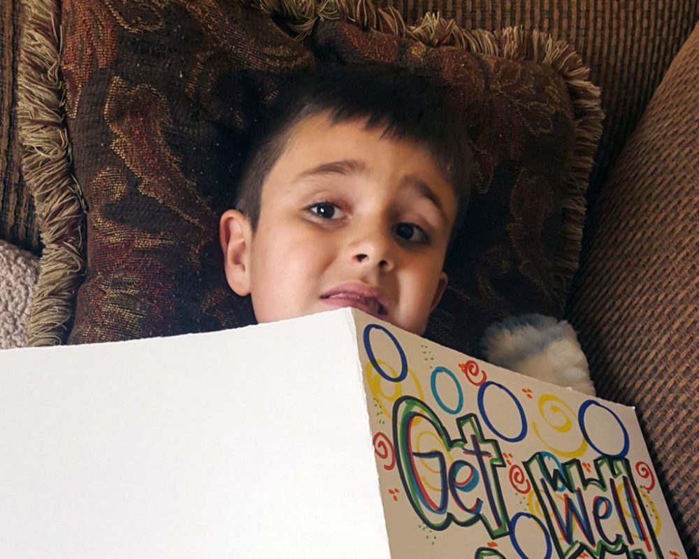 Levi reading a get well soon card