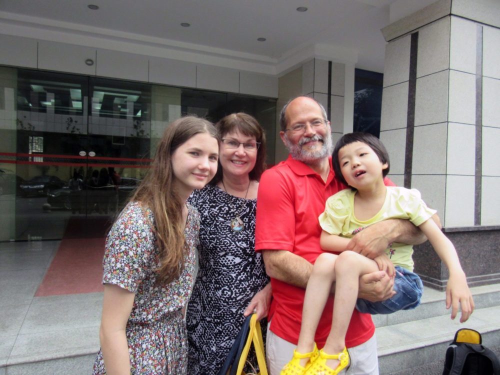 Sonnet Being carried by her dad