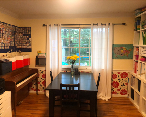 A room with a table and a piano.