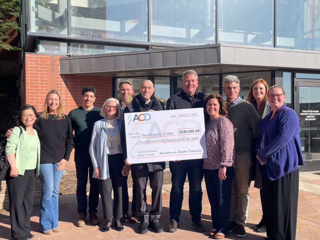 The ACD board delivering a check to the University of Utah.
