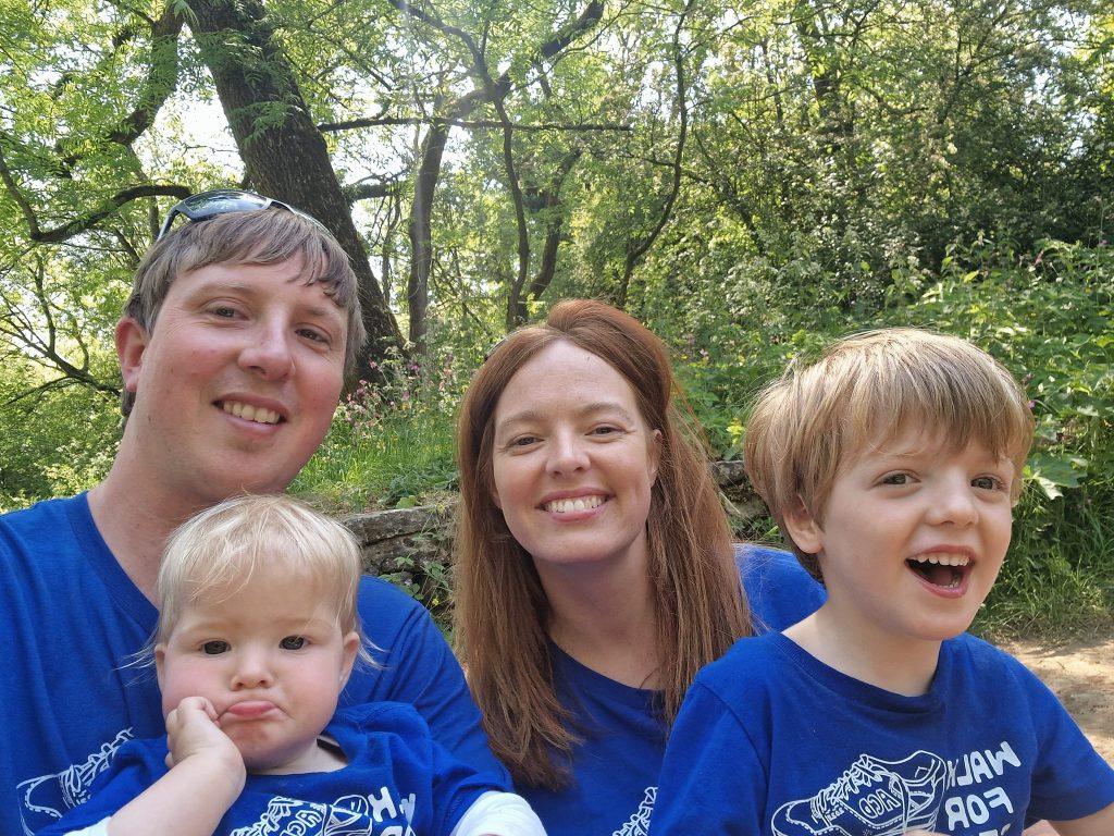 A family wearing Walk for Strength shirts